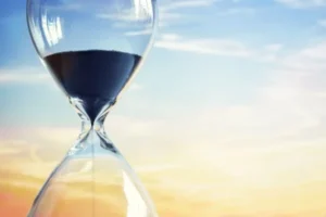 An hourglass with a serene background