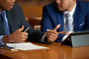Two businessmen having a discussion while sitting at a table