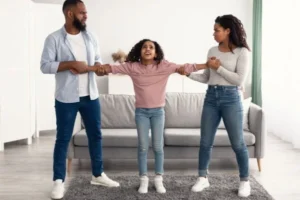 Father and mother attempting to separate the child from each other.