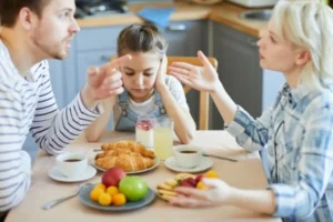 A family sitting at a breakfast table