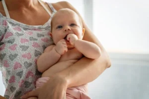 A woman gently cradling a baby in her arms