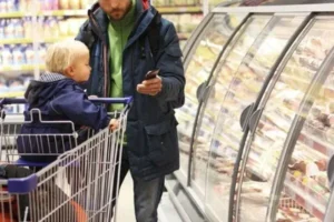 A man and child in a grocery store