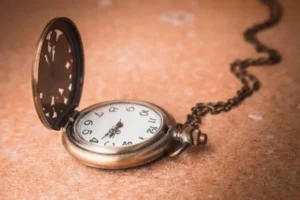 A gold pocket watch with a chain