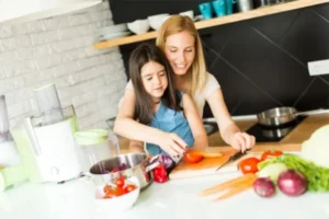 A mother and daughter bonding while cooking in the kitchen